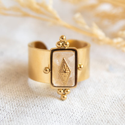 Gold ring with rectangular stone and diamond detail