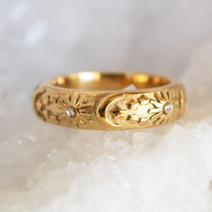 Gold celestial ring with sun and moon motifs