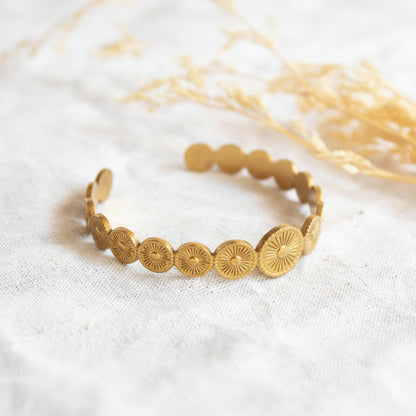 Gold sun motif cuff bracelet