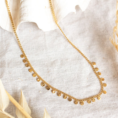 Gold necklace with scattered coin charms