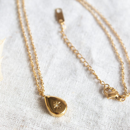 Gold droplet necklace with star and diamond accent