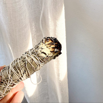 Small sage smudge stick tied with white string